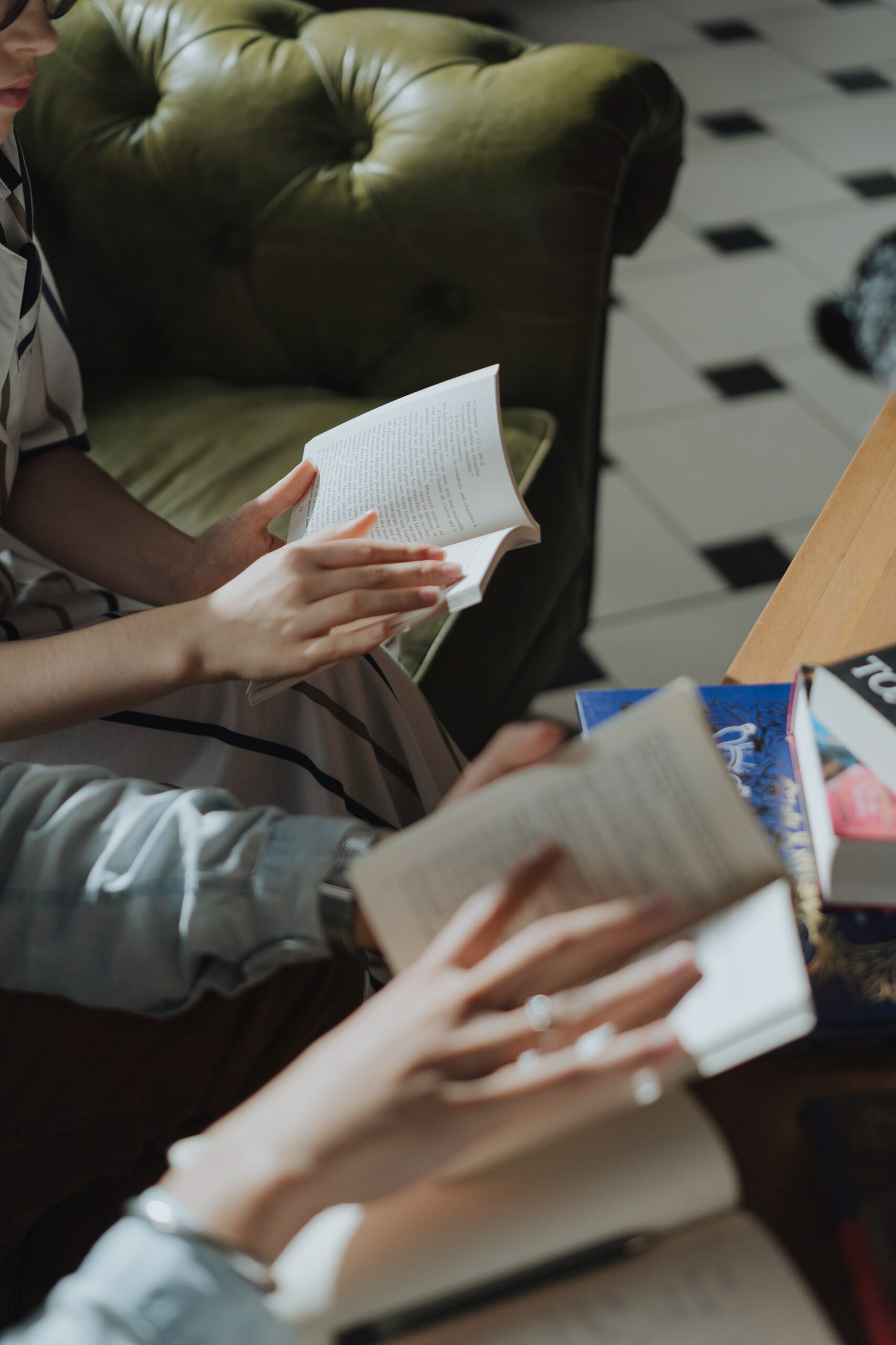 Two people paging through a book