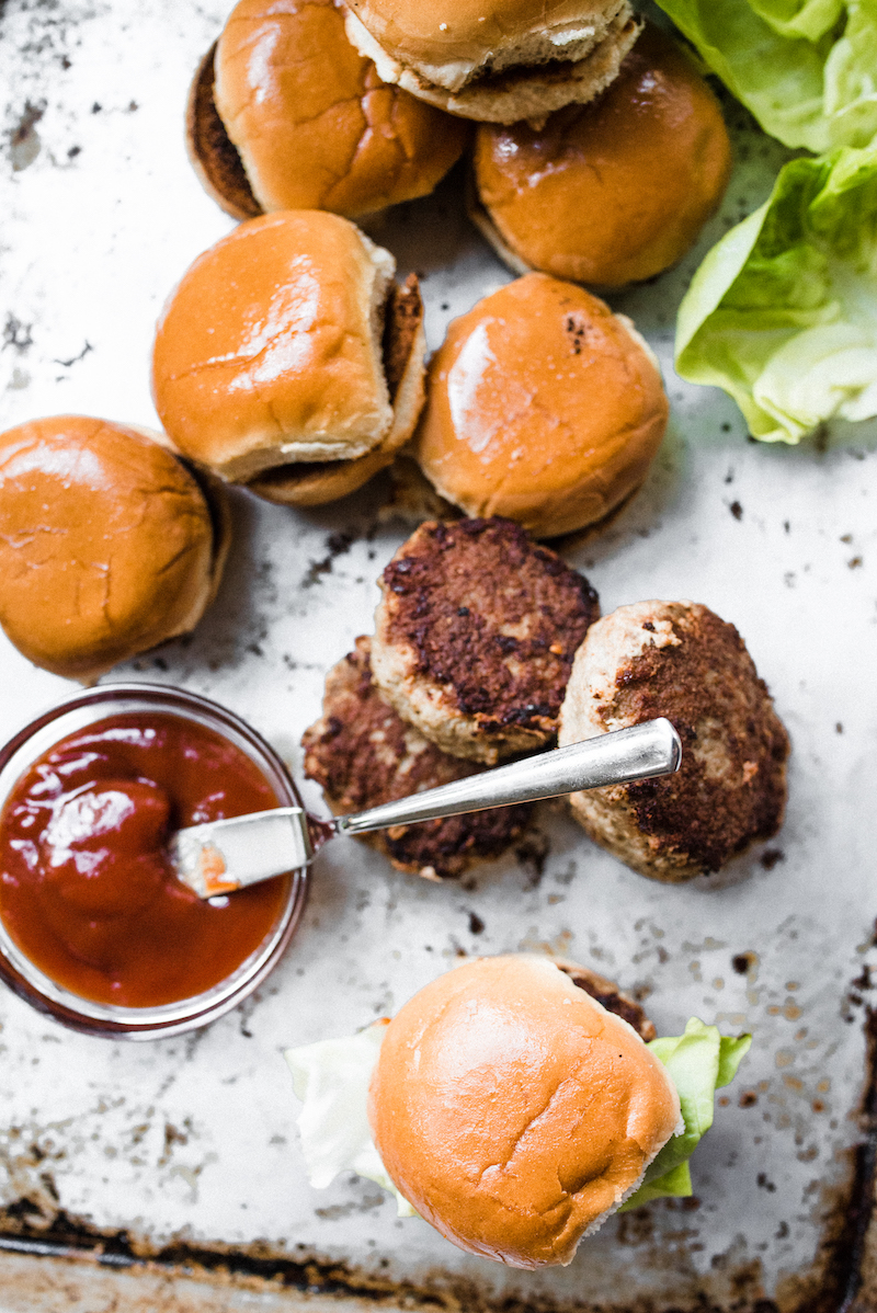 A tray of buns, patties, and ketchup - the ingredients for the Turkey Sliders Recipes