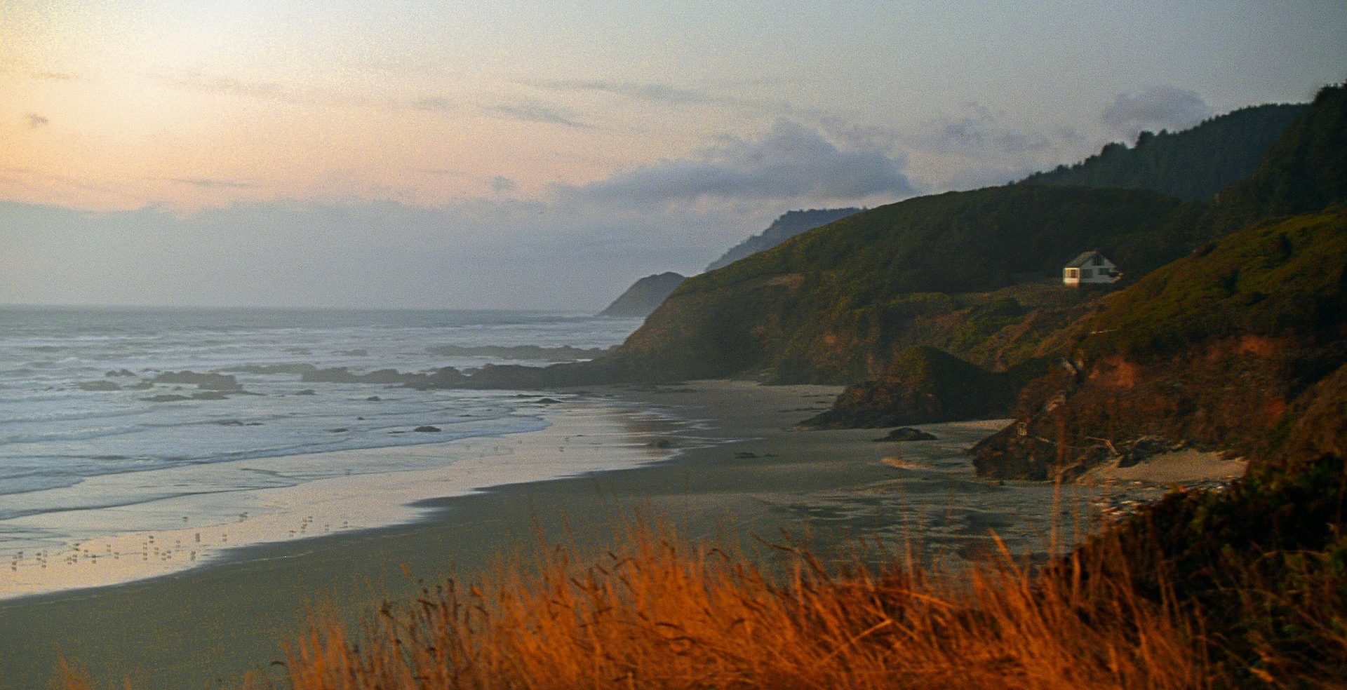 A shoreline surrounded by cliffs at sunset - Seasonal Affective Disorder