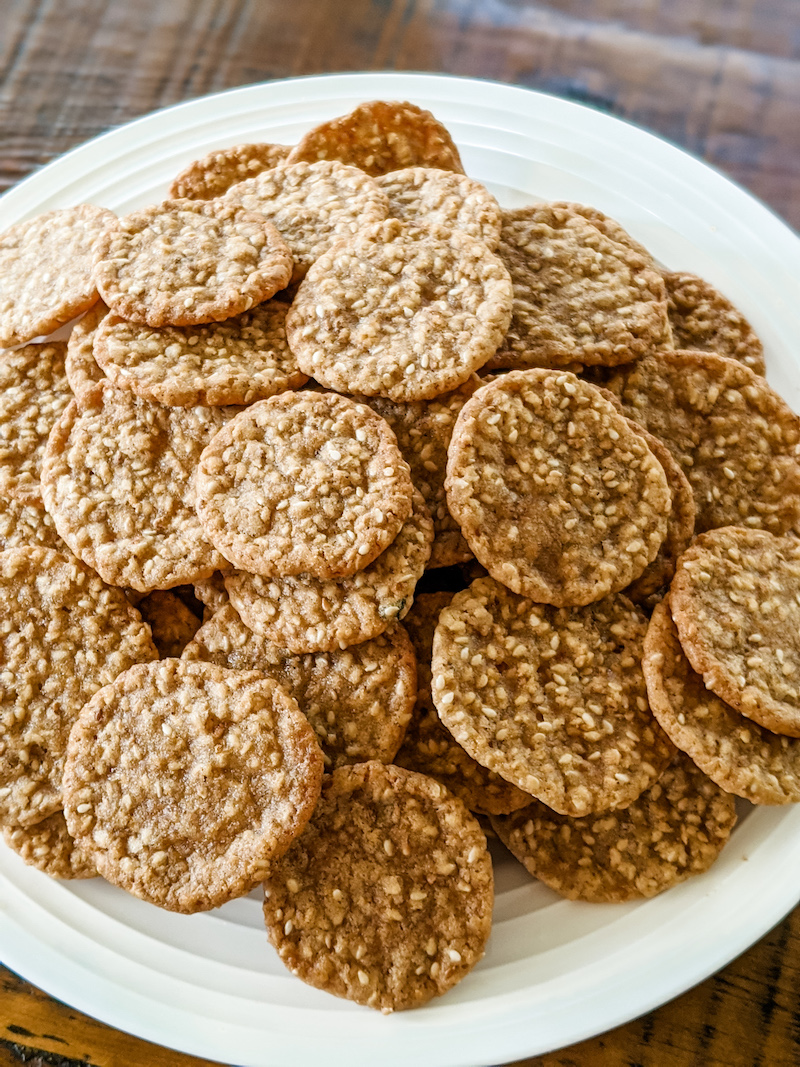 A plate filled with a stack of benne wafers