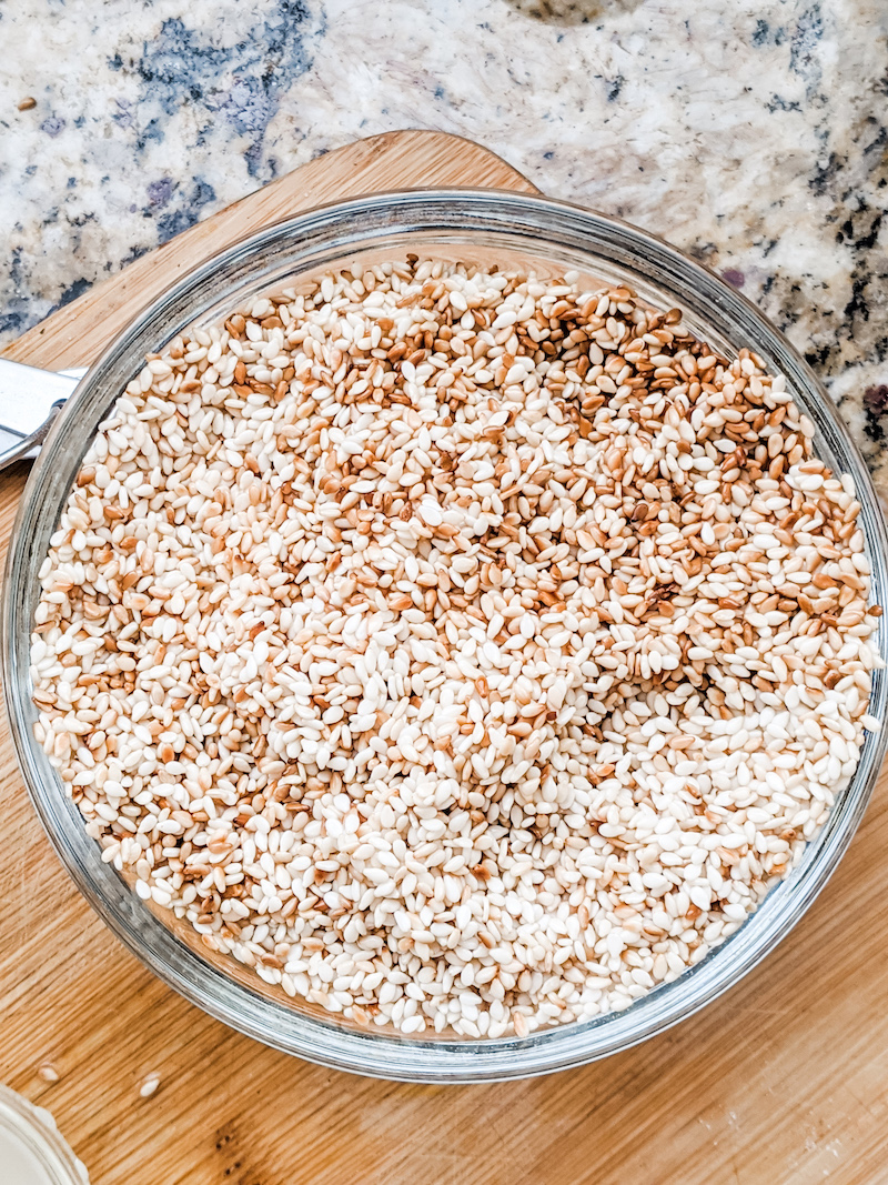 A clear bowl of toasted sesame seeds