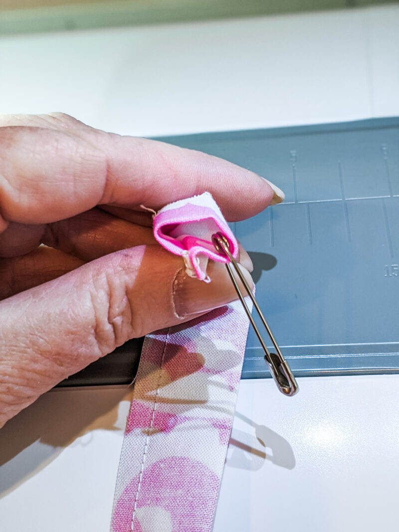 Safety pinning the strip of fabric