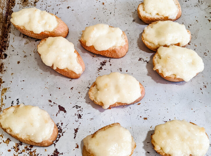 The 3 ingredient appetizer, easy parm bread pieces on a pan, waiting to be baked