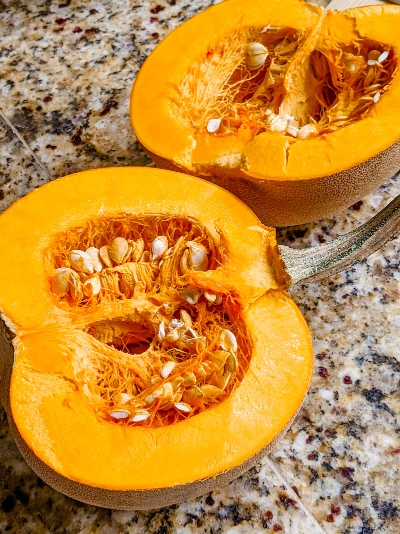 A sugar pumpkin that's been sliced in half