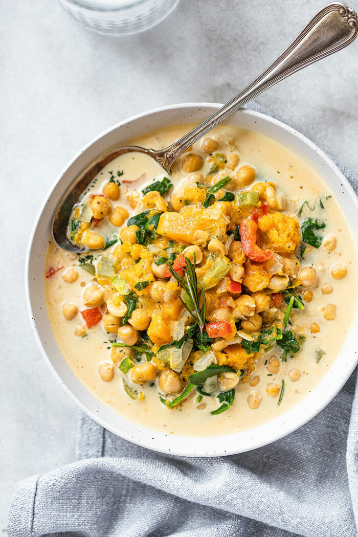 One of the Crocktober Recipe Round-Up dishes - chickpea stew in a bowl garnished with fresh herbs