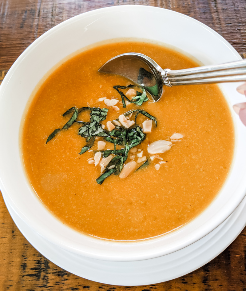 The Slow Cooker Thai Butternut Squash Soup served in a bowl with a spoon set in it
