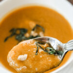 The finished Thai Butternut Squash Soup, with a spoon picking up a bite.