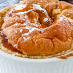 A close up of the finished Pumpkin Soufflé with Bourbon Molasses Sauce
