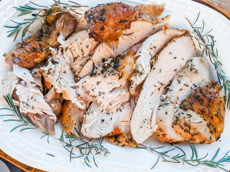 The finished and sliced small scale oven roasted turkey breast on a platter for a small scale Thanksgiving