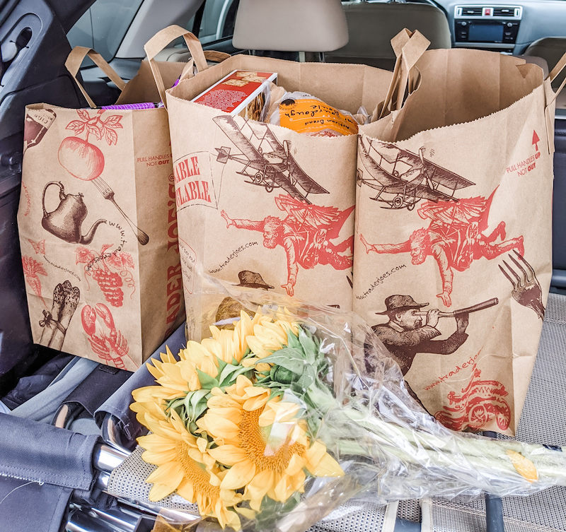 Trader Joe's Winter Favorites, bagged and loaded into a car trunk.