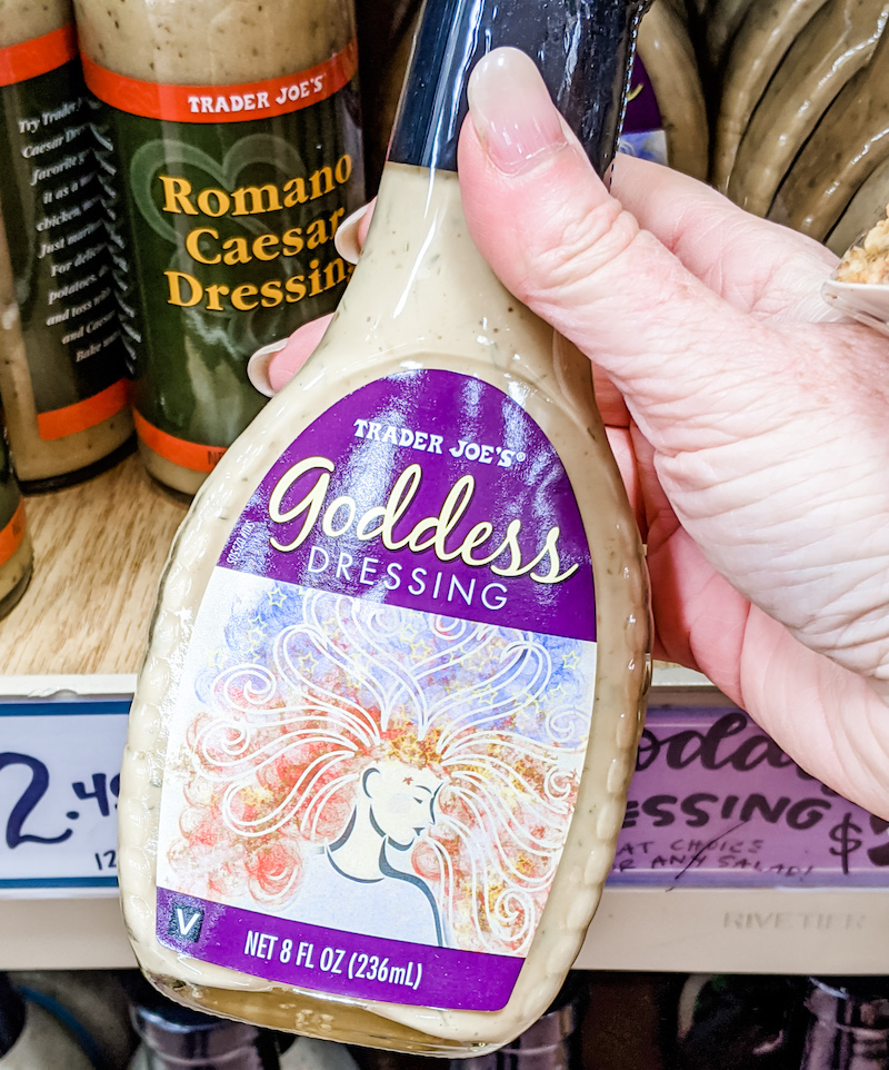 A hand holing the Trader Joe's Green Goddess Salad Dressing