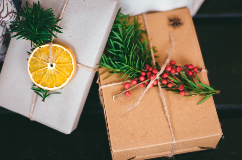 Two presents wrapped in paper and with flowery ornaments.