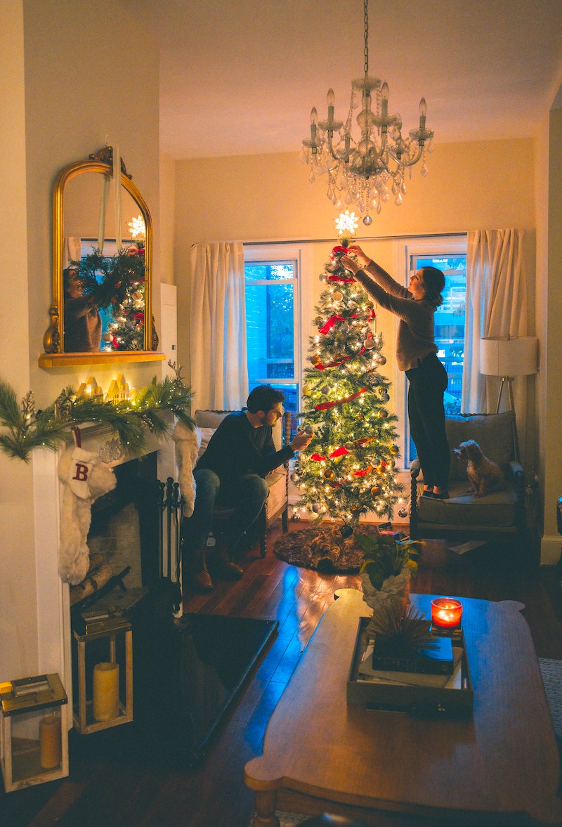 Celebrate Christmas from Home - a couple decorates their house and tree.