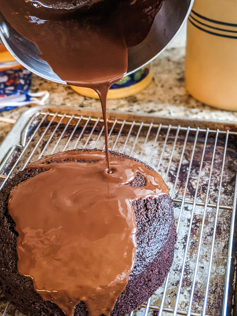 The glaze being poured onto the Chocolate Peppermint Beet Cake