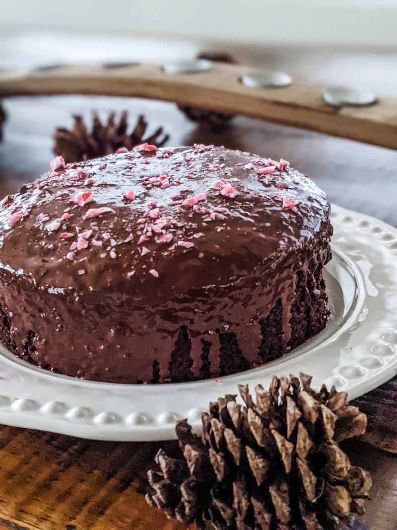 Another view of the finished Chocolate Peppermint Beet Cake, surrounded by pinecone decor