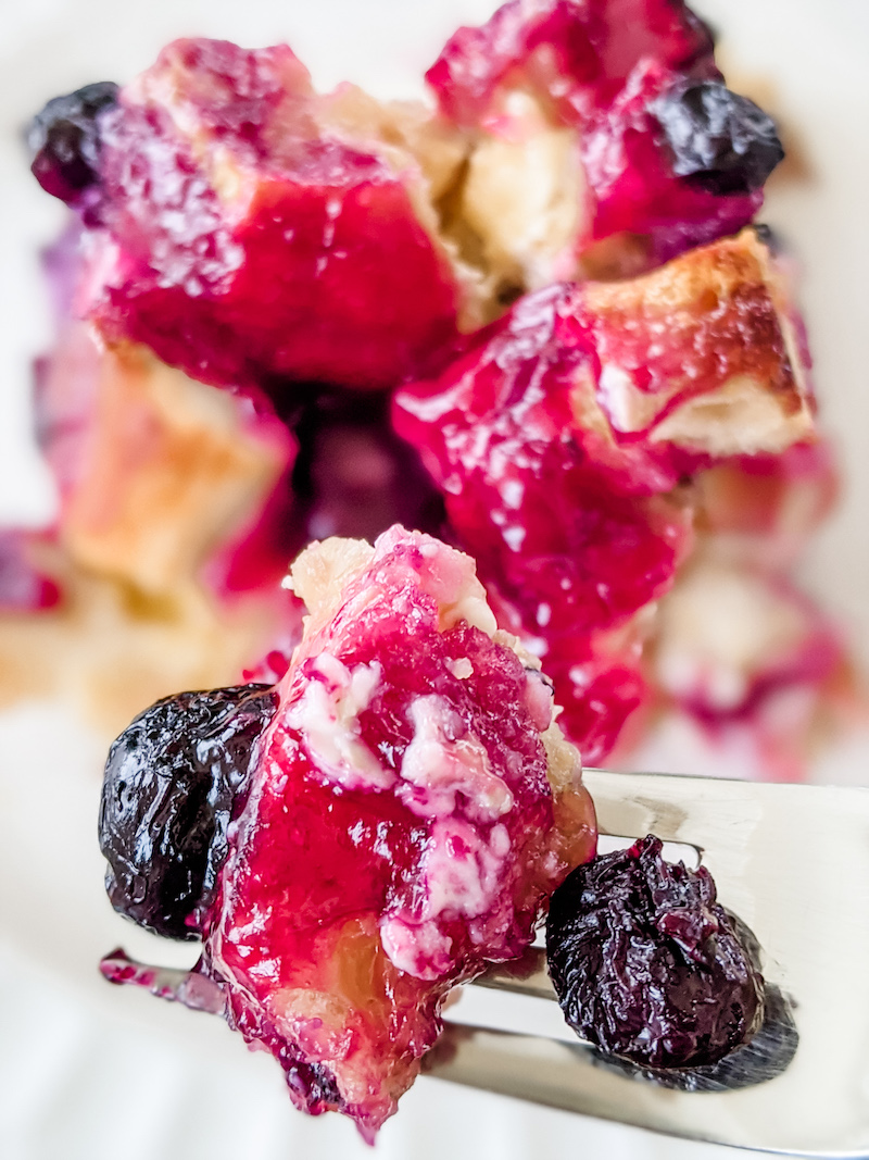 A fork holding some of the Easy Blueberry Lemon Breakfast Casserole