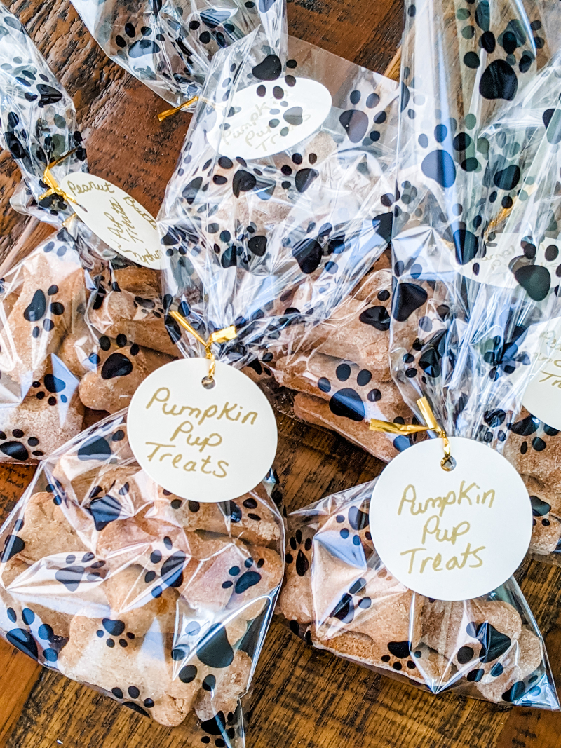 Several paw-printed bags with the homemade Pumpkin Dog Biscuits.