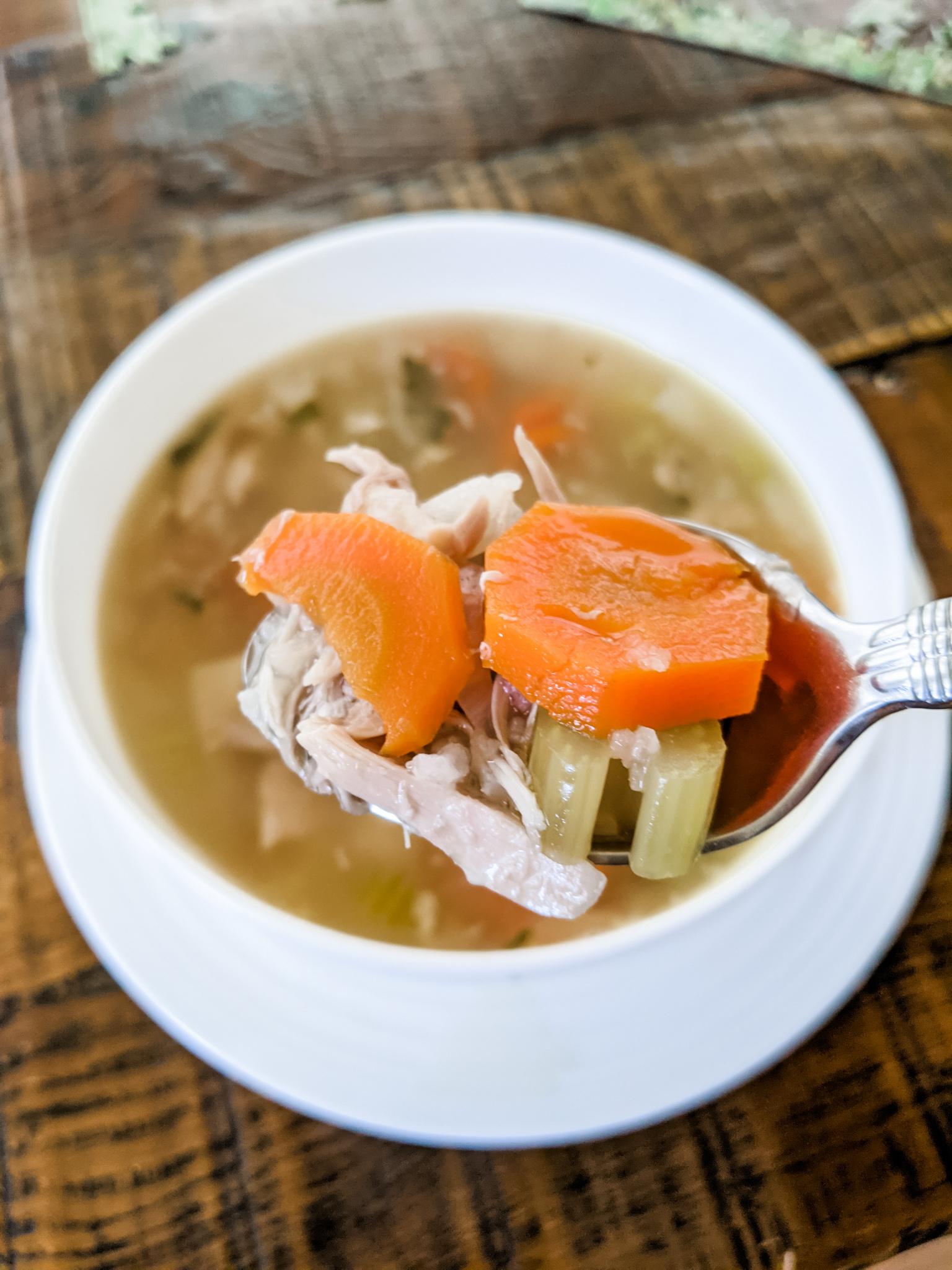 A bowl of the Leftover Turkey Soup Recipe with a spoonful being lifted out