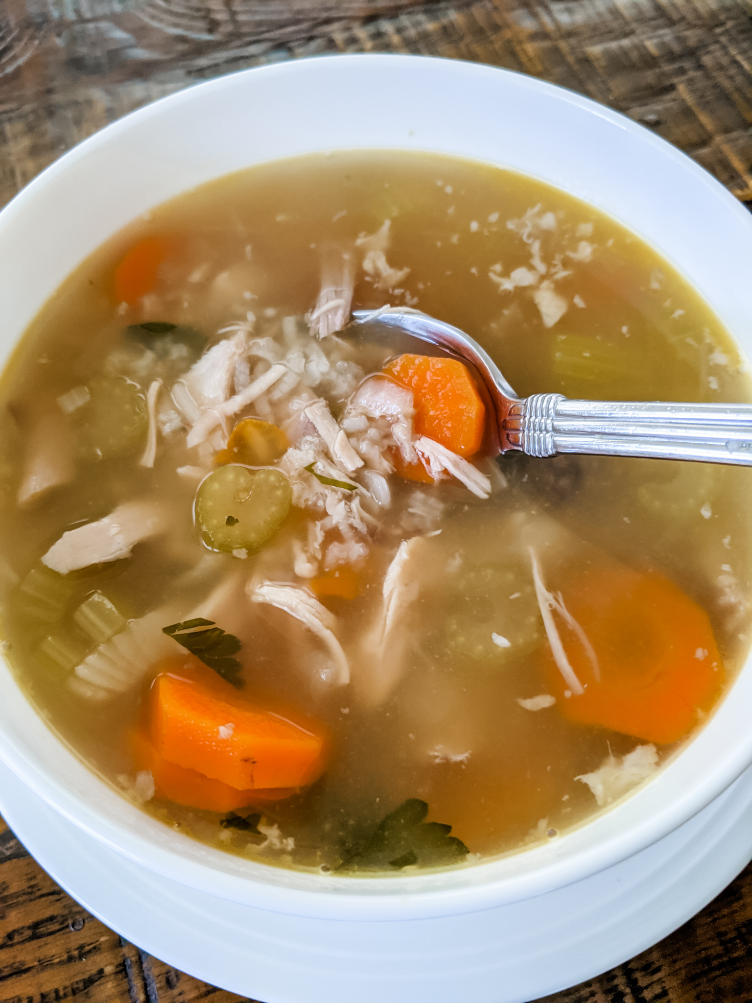 A bowl of the finished Leftover Turkey Soup Recipe with a spoon in it