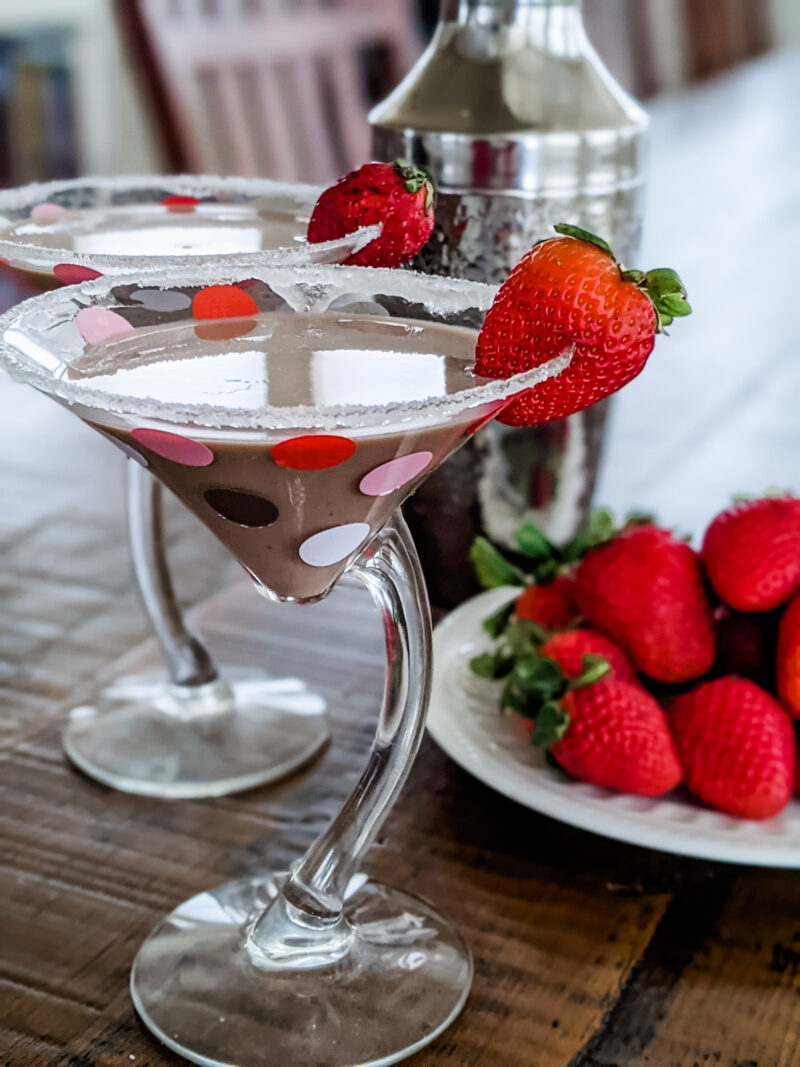 The Chocolate Martini Cocktail in two glasses. topped with strawberries