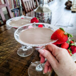 Marie holding one of the Chocolate Martini Cocktail, garnished with strawberries