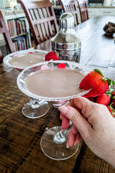 Marie holding one of the Chocolate Martini Cocktail, garnished with strawberries