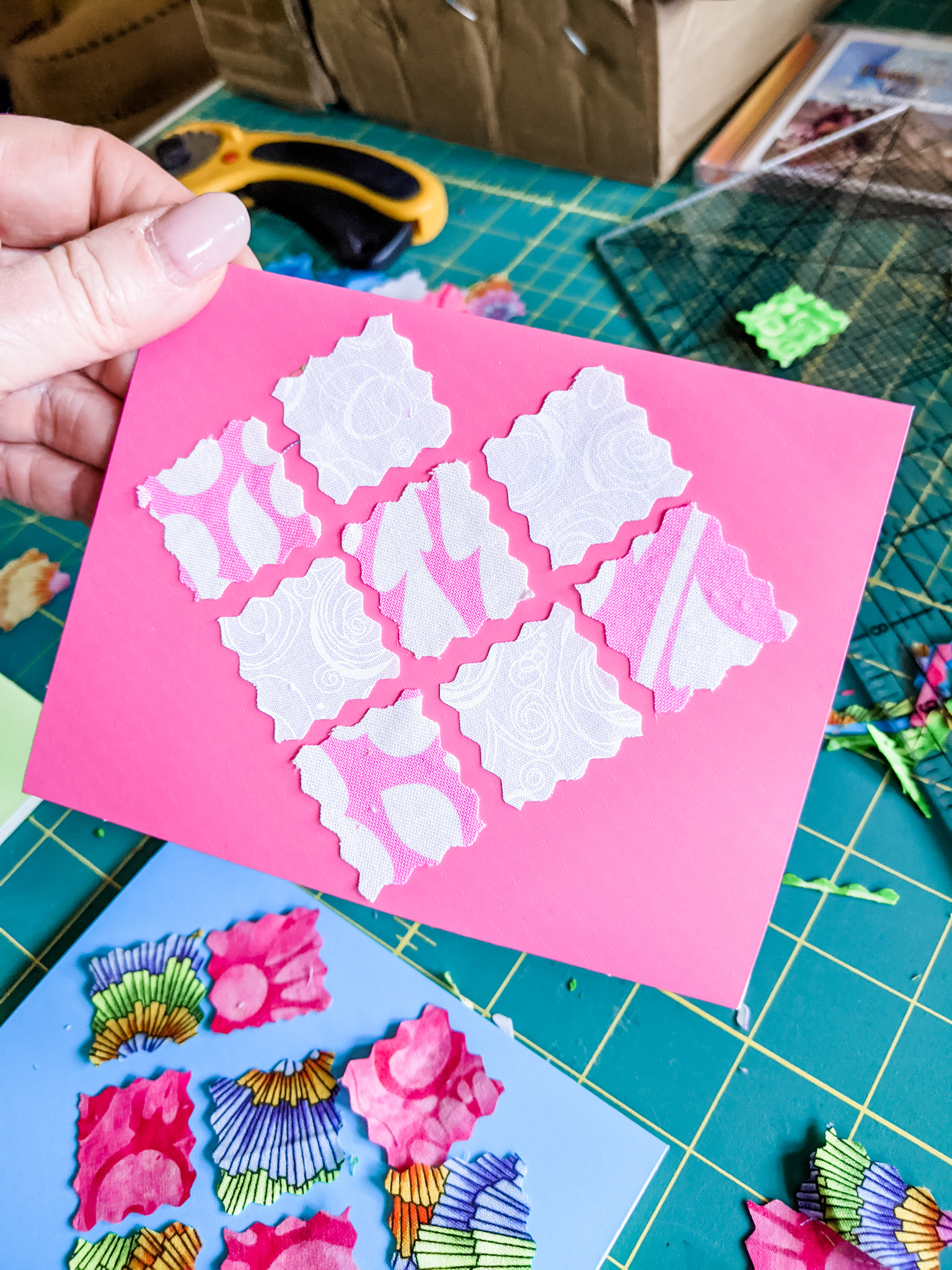 Marie holding one of the finished Fabric DIY Valentines above her crafting supplies.