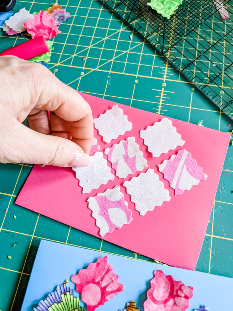 Marie placing done the fabric scraps into a heart-shaped pattern