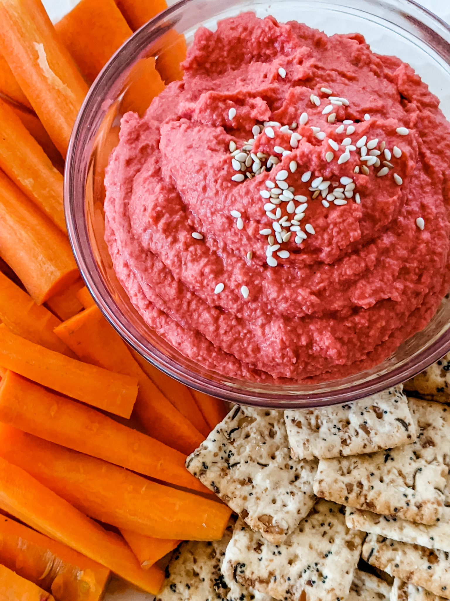 The Homemade Beet Hummus alongside sliced carrots and crackers