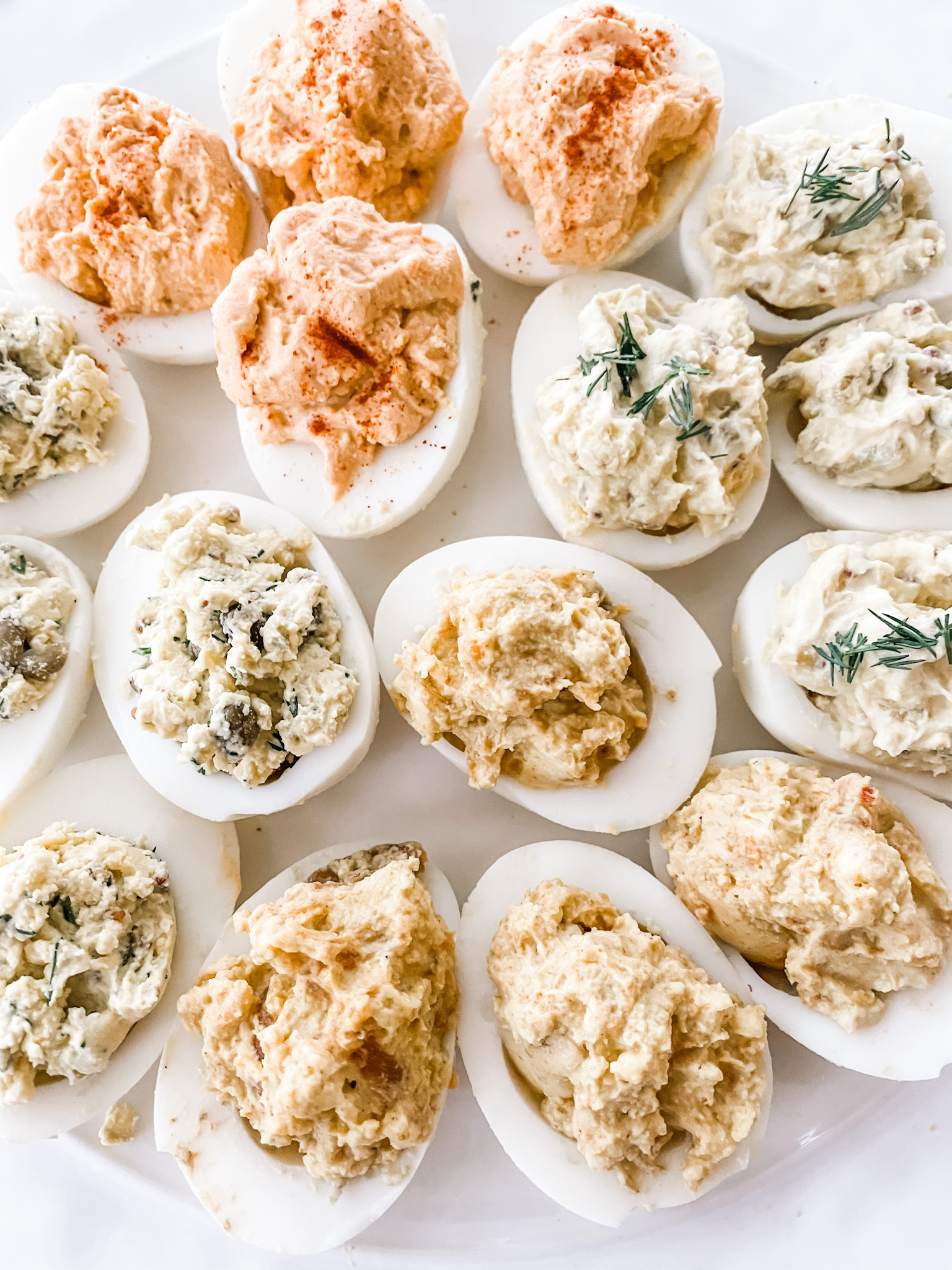 All four variations of Maries lighter deviled eggs on a white plate