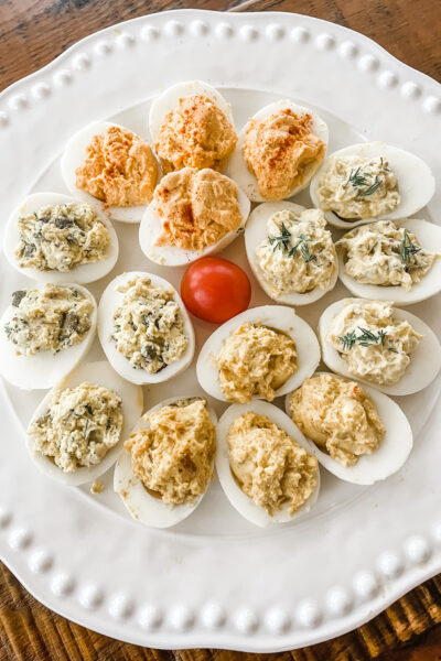 All four variations of the lighter deviled eggs on a white plate.