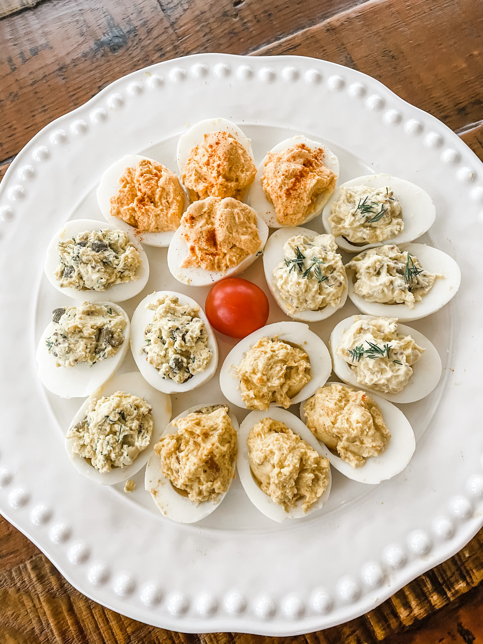 All four variations of the lighter deviled eggs on a white plate.