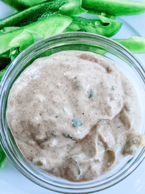 The Lighter Southwestern Buttermilk Ranch Dressing next to sliced green bell peppers.