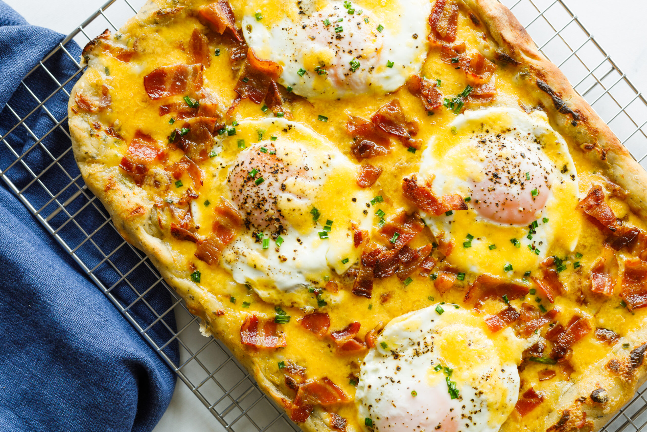 The finished Easy Bacon and Egg Pizza on a cooling rack