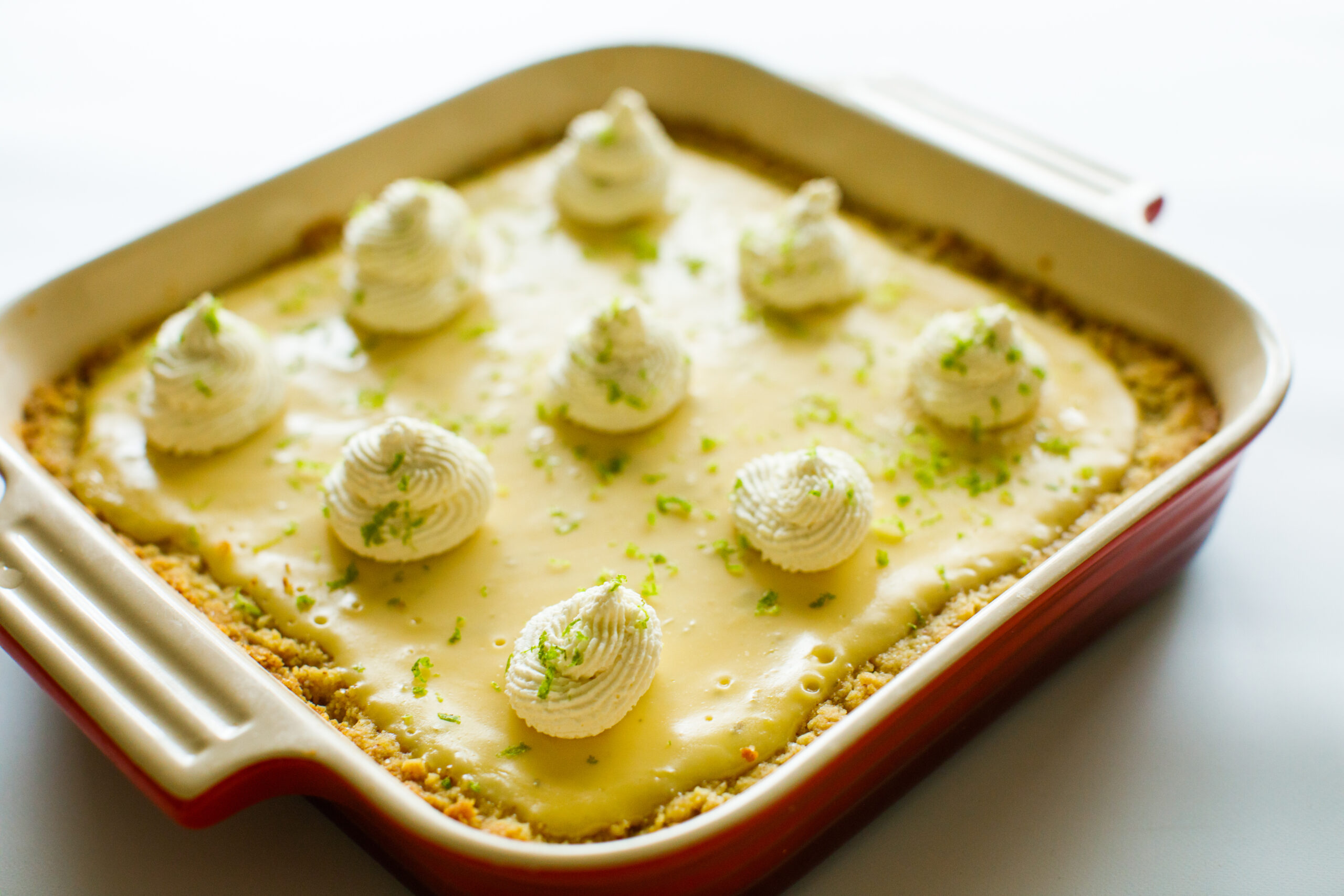 The finished Key Lime Pie Bars in a red baking dish