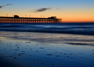 A picture of a dock along the Lowland/South Carolina shoreline at sunset