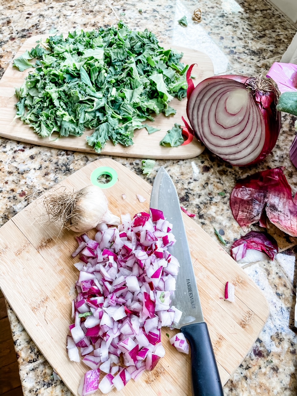 Chopped kale and red onion on a cutting board