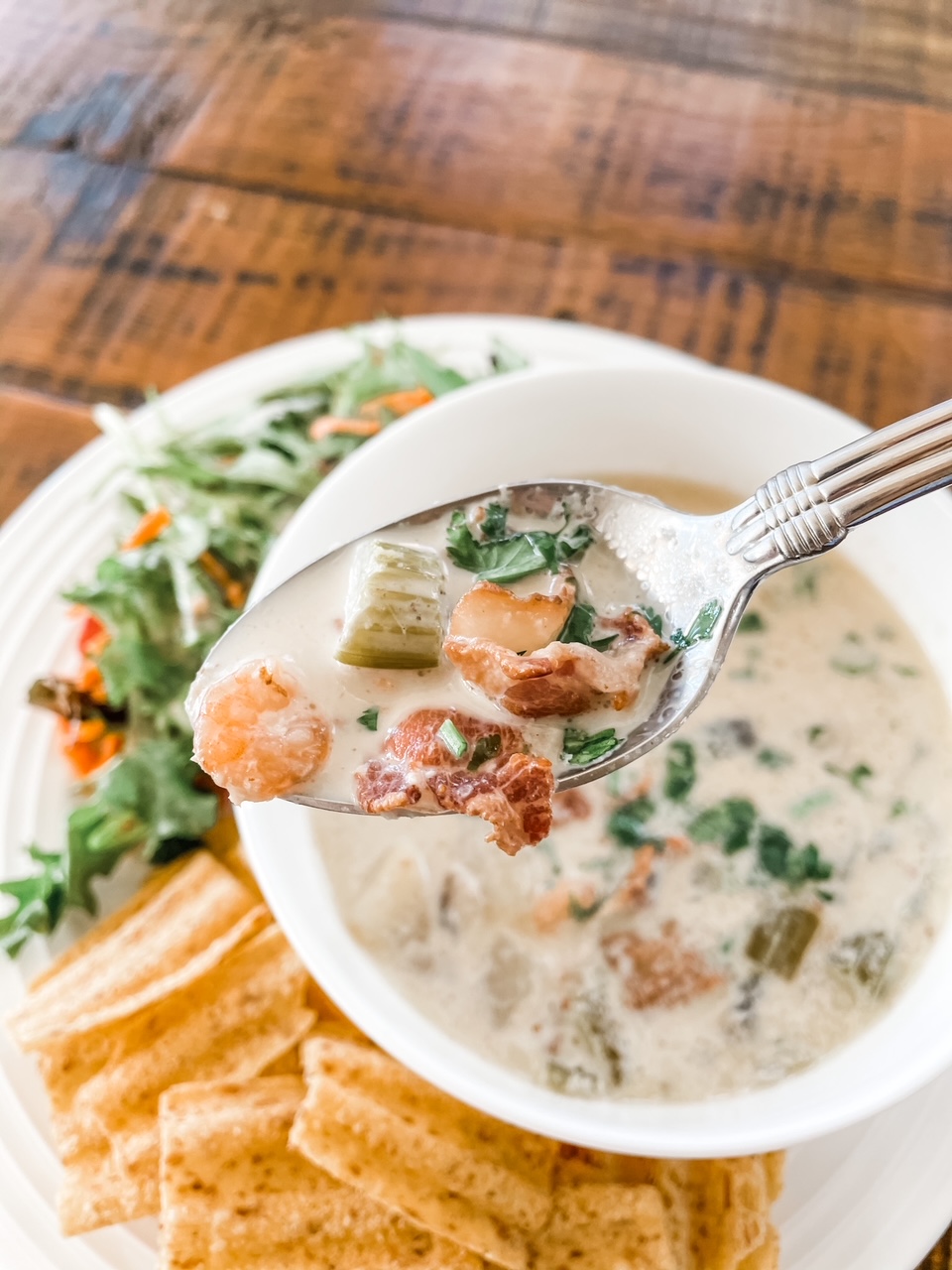 A bowl of the Quick and Creamy Seafood Chowder with a spoon