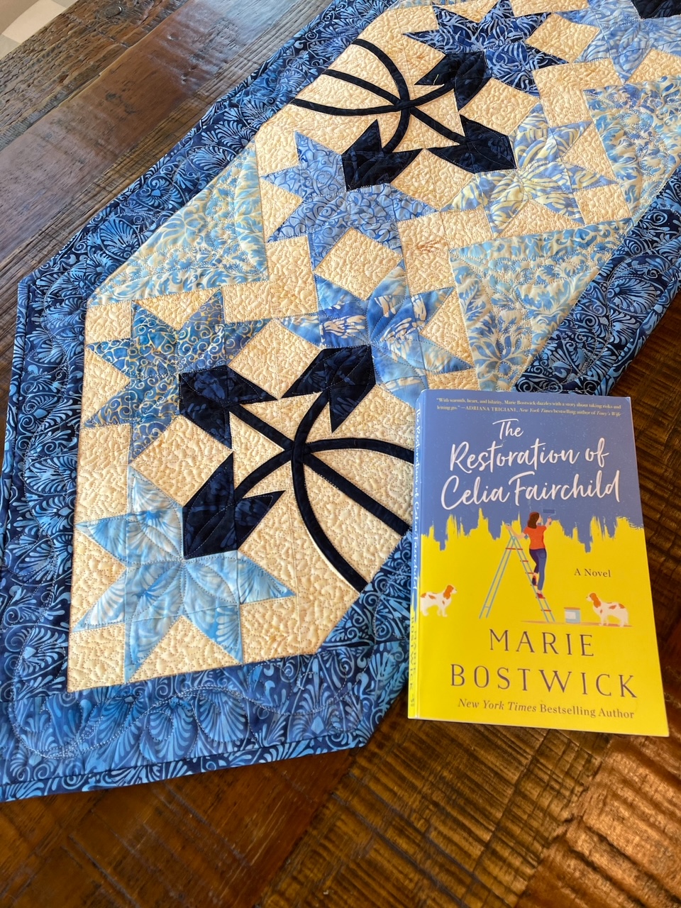 A close up of the quilted table runner and the book that inspired it.