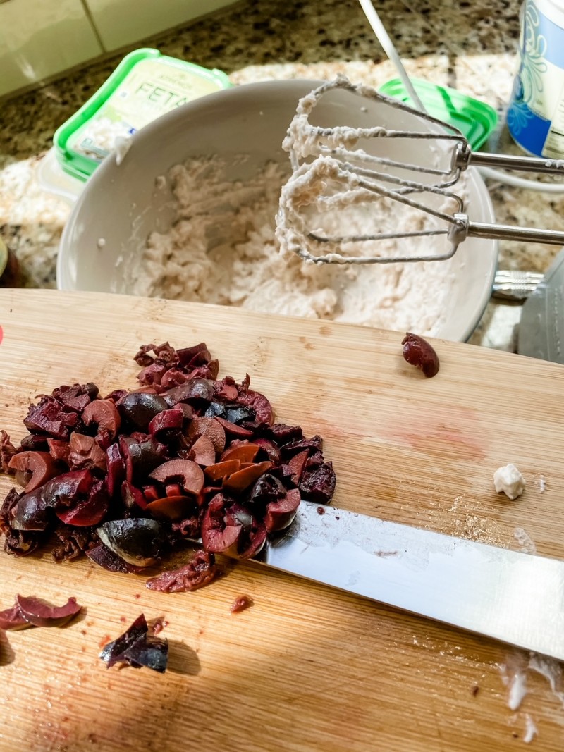 The chopped kalamata olives on a cutting board.