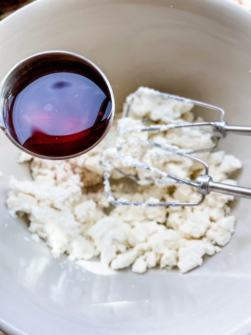 The olive oil being mixed into the feta cheese.