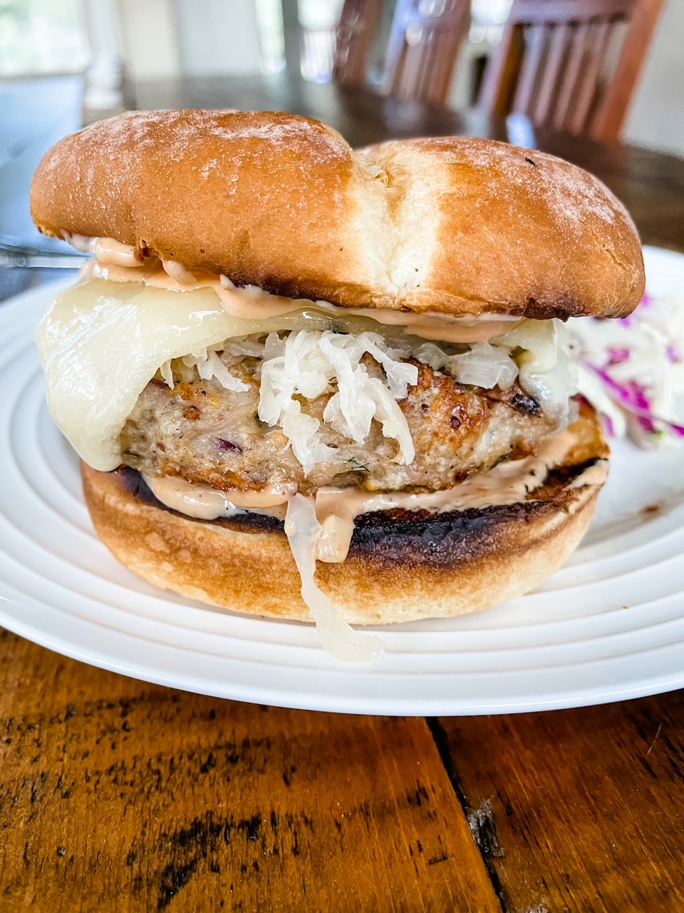 The finished burger on a plate, piled high with sauerkraut 