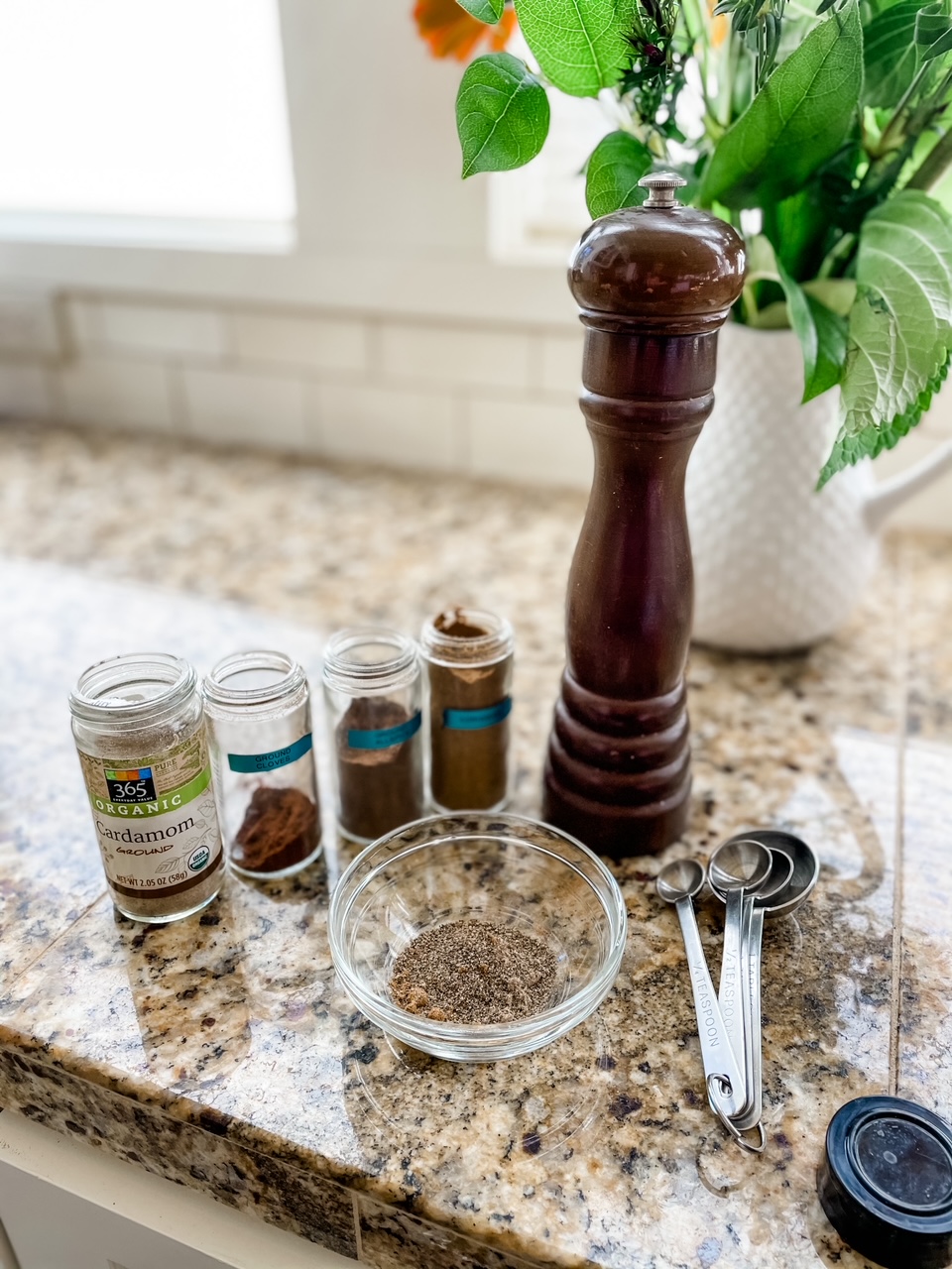 The spices lined up on a countertop.