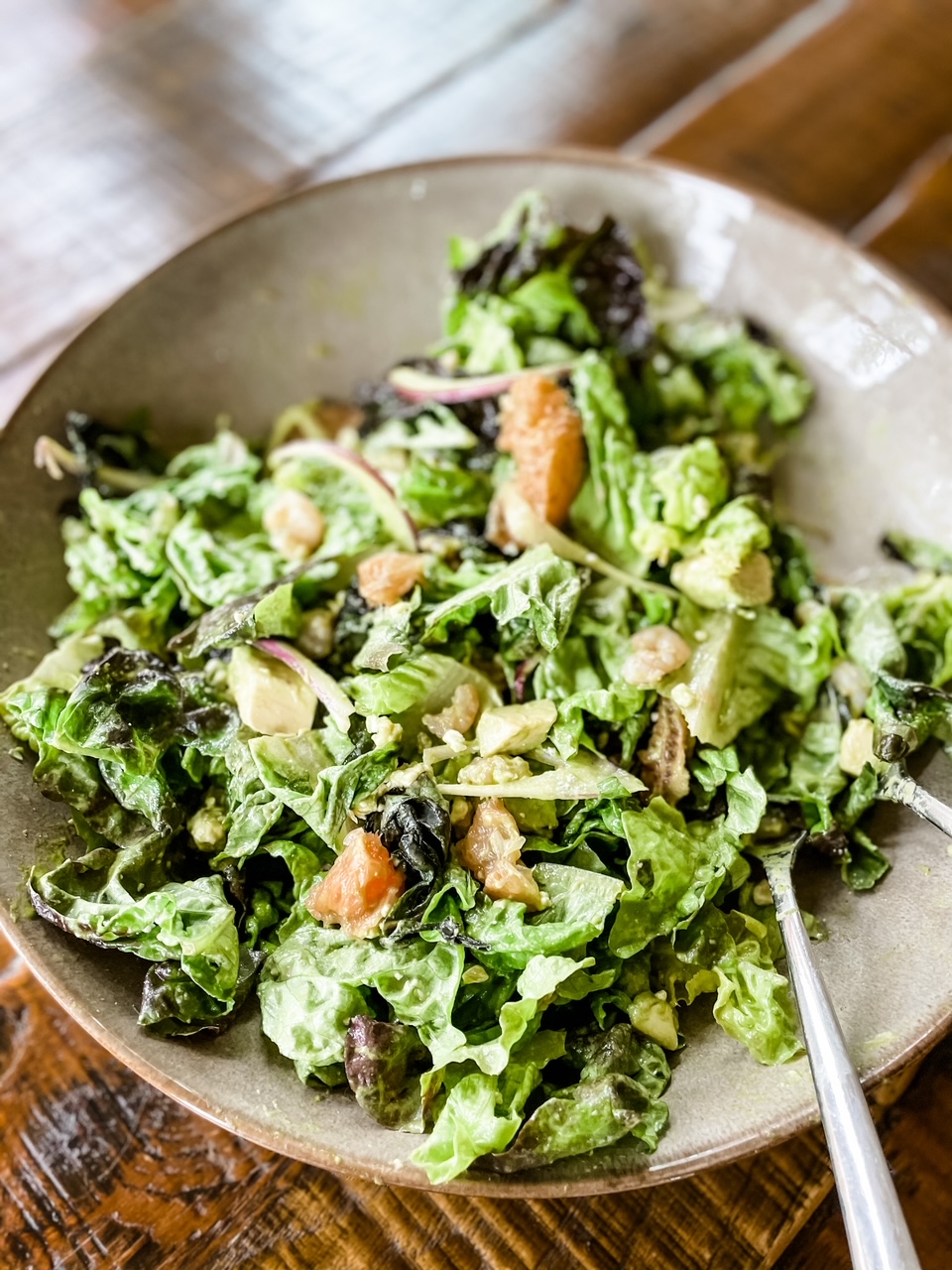 The Grapefruit and Gorgonzola Salad with Shrimp in a bowl, mixed with a fork