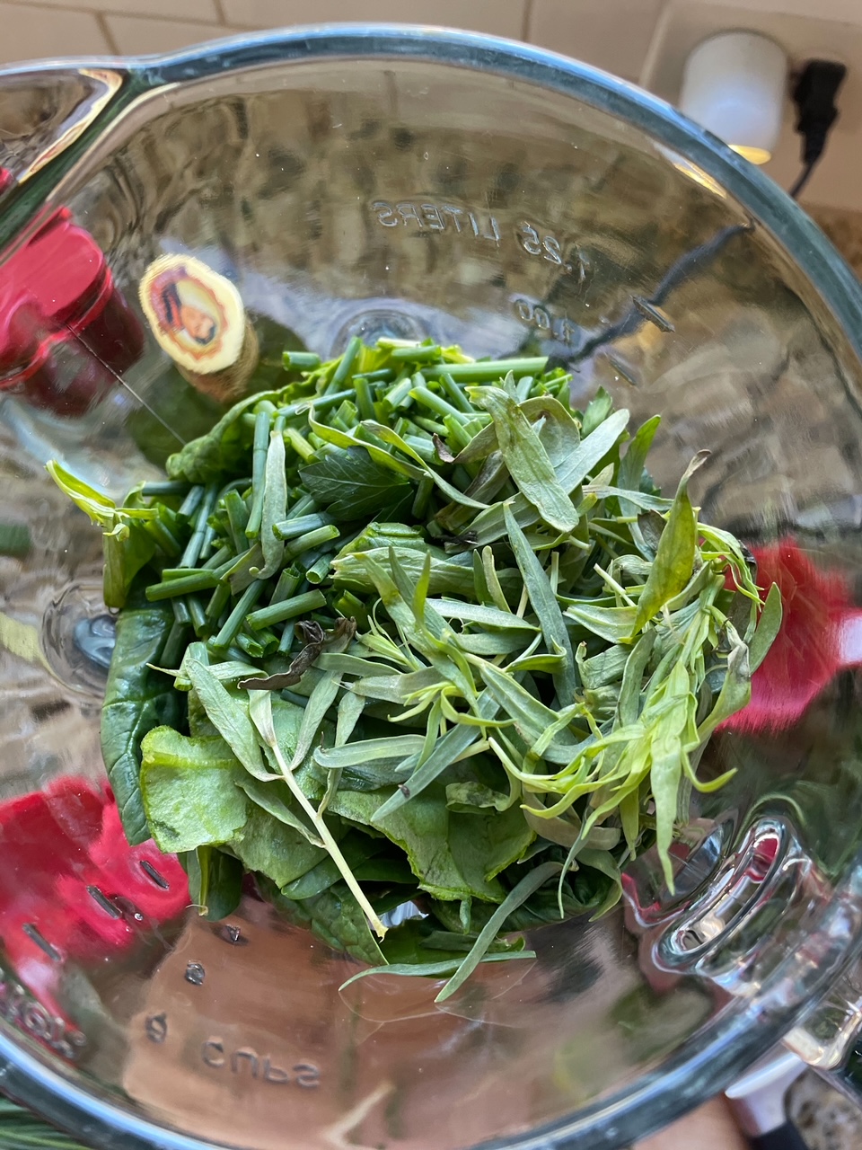 The greens for the Homemade Green Goddess Salad Dressing in a blender, not yet blended