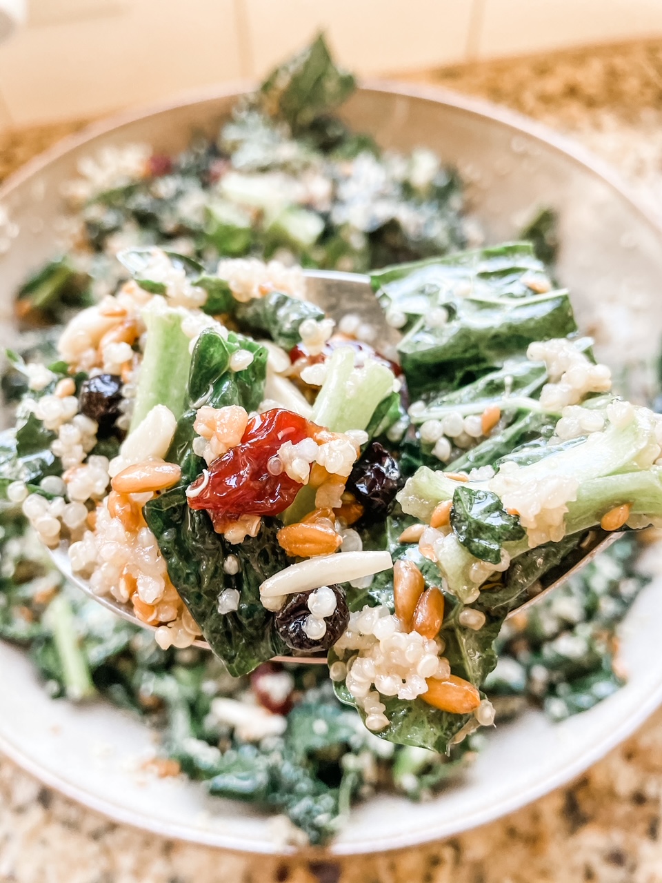 A forkful of the Kale Superfood Salad Recipe held over a bowl