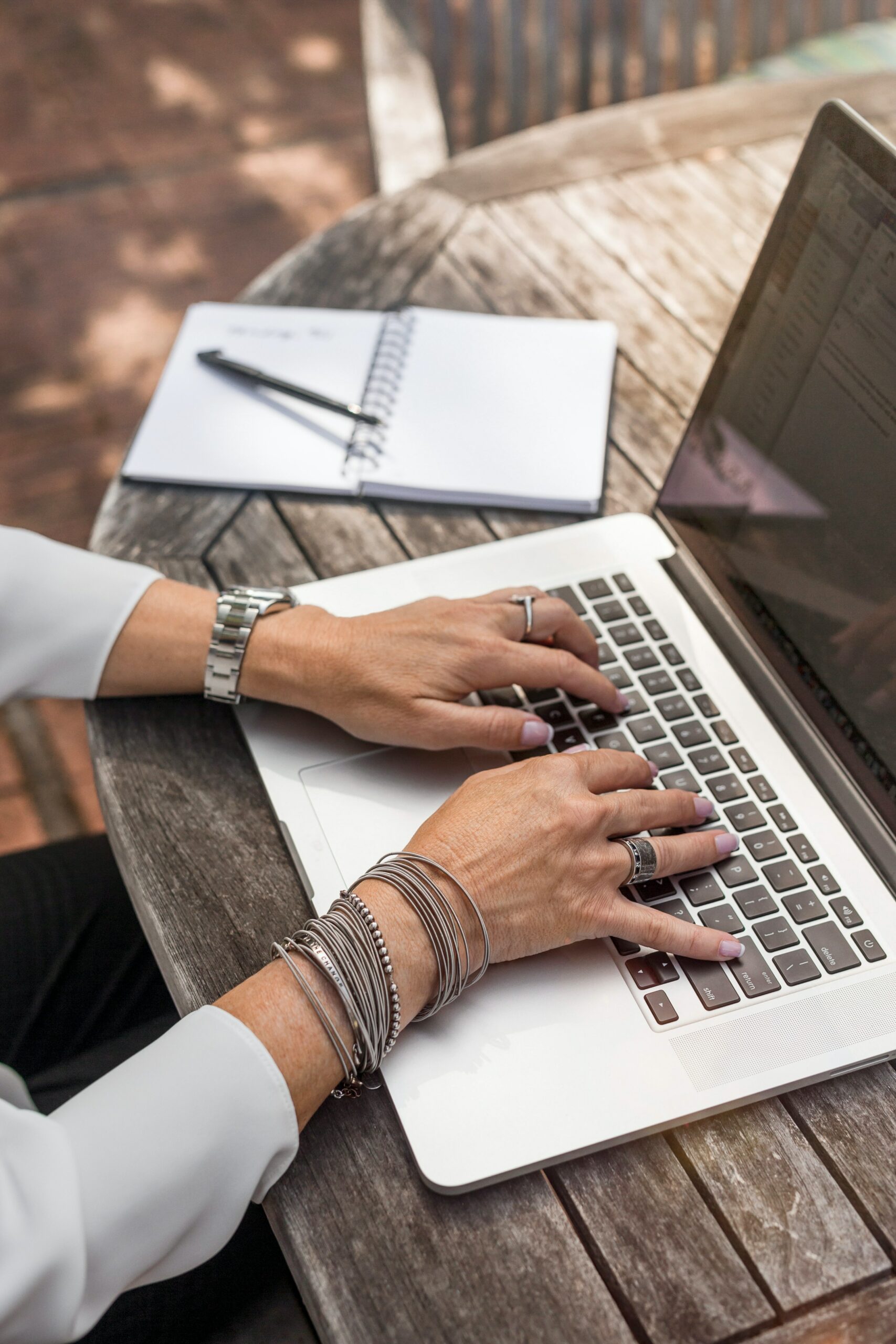 Dealing with Critic's Math: A woman types on a laptop outdoors