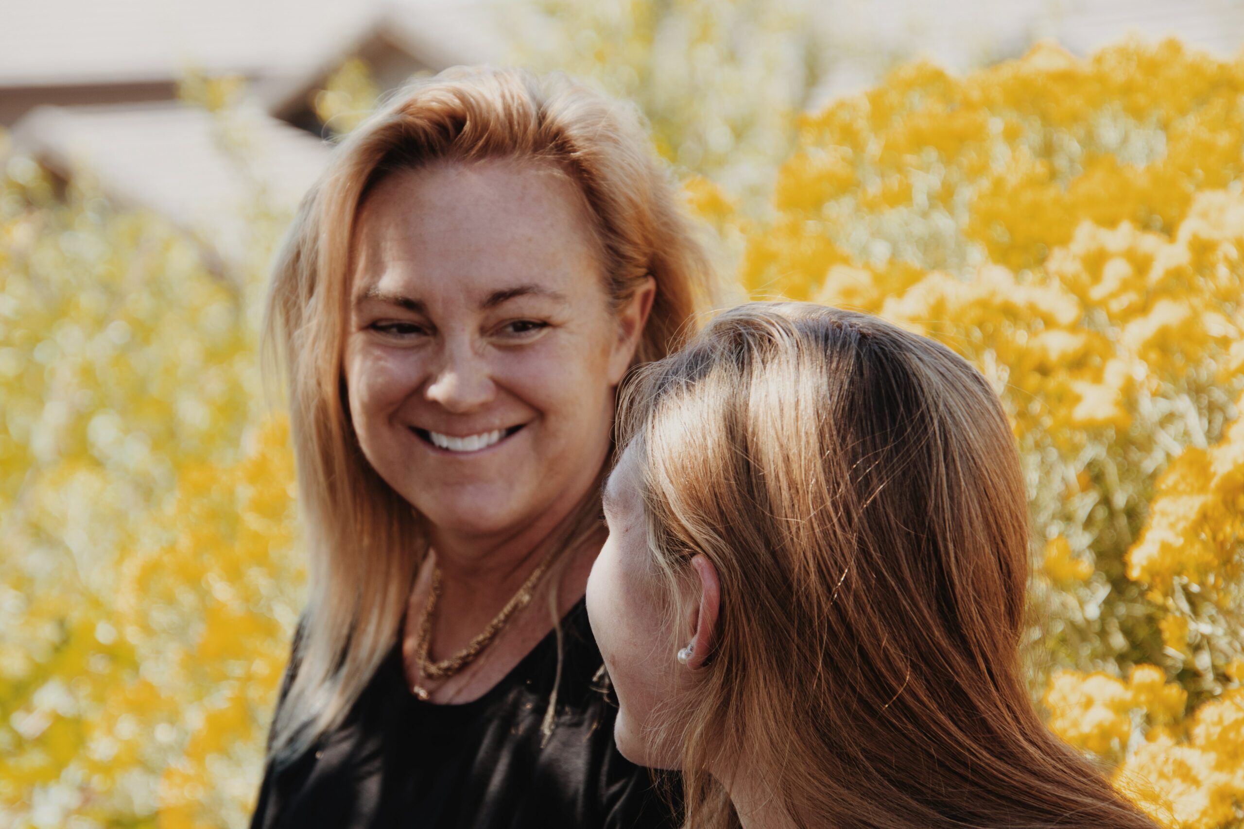 Dealing with Critic's Math: Two women smile at each other.