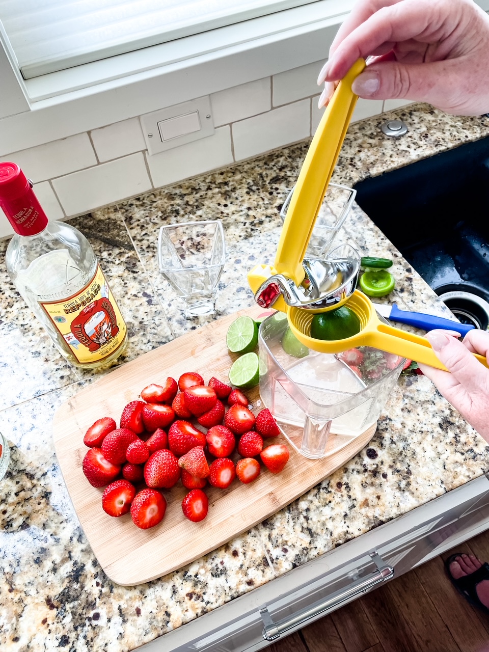 Marie squeezing some of the fresh limes alongside the other ingredients