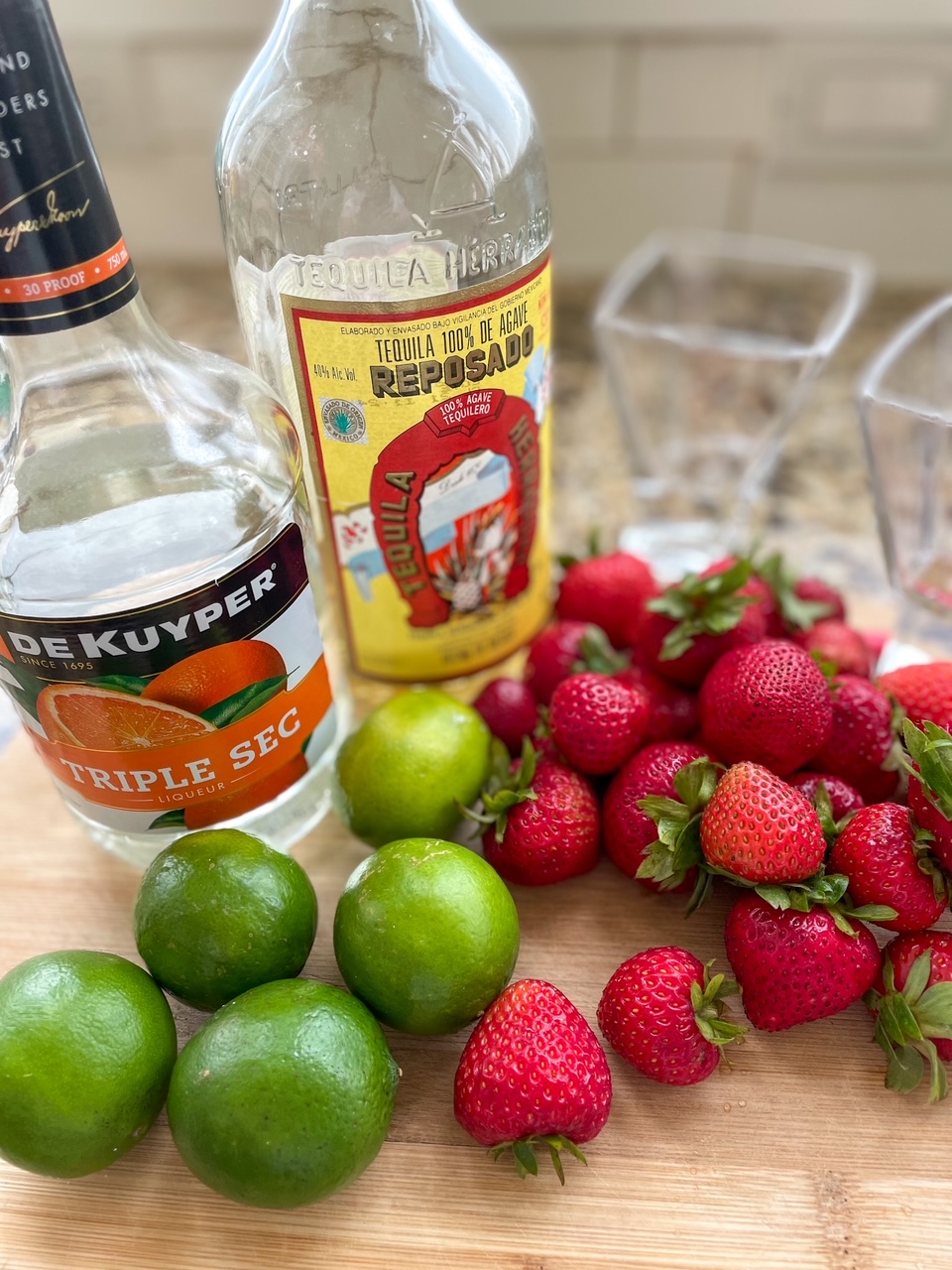The ingredients for the Fresh Strawberry Margaritas - tequila, triple sec, limes, strawberries and simple sugar